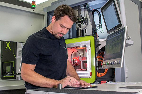 An employee adjusts the laser process